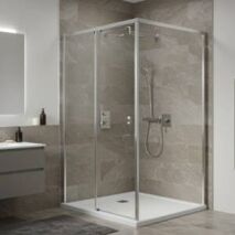 Modern bathroom featuring a semi-frameless corner shower screen with a sleek silver frame. The shower enclosure maximises space with a contemporary design, complemented by neutral-toned tiles, a floating vanity, and a heated towel rail