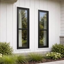 Narrow black framed double hung windows on an architectural home