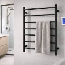 Matte black heated towel ladder with timer control installed in a modern bathroom