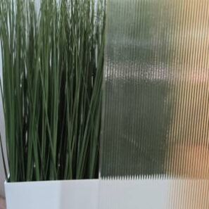 Fluted glass screen infront of plant