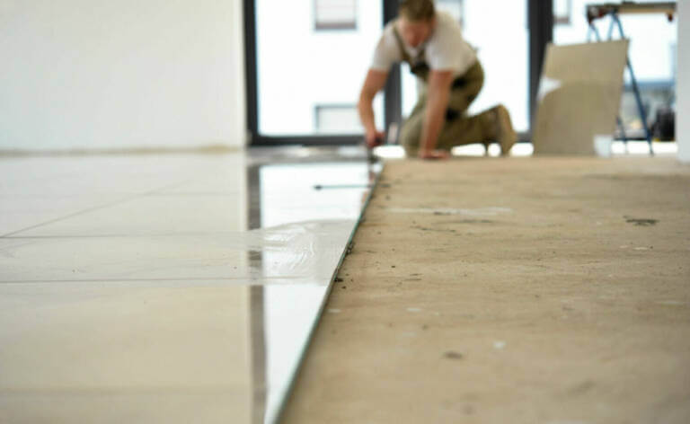 laying tiles over floorboards