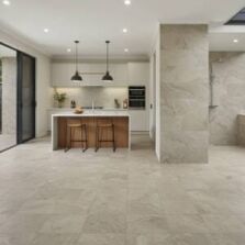 Modern home featuring porcelain and ceramic tiles, with a spacious open-plan kitchen, stylish splashback, durable tiled flooring, and an outdoor patio with stone-look porcelain tiles