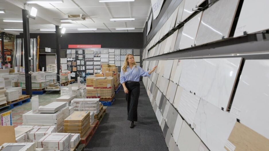 Customer browsing wall tile displays at Ross’s Discount Home Centre showroom in Perth, featuring a wide range of quality tiles for bathrooms, kitchens, and floors