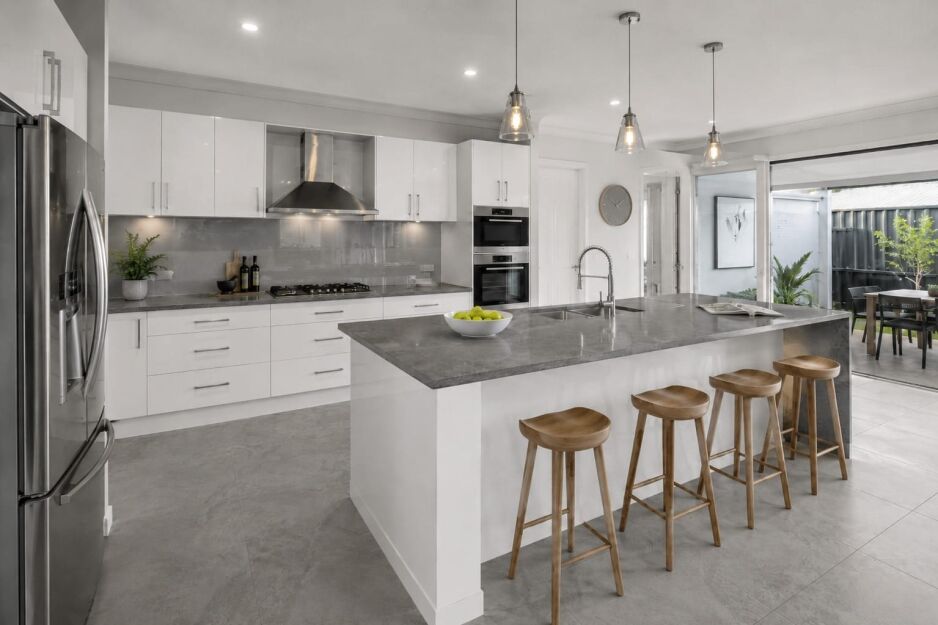 Modern grey and white kitchen with glossy white cabinets, grey benchtop, grey splashback and grey floor tiles