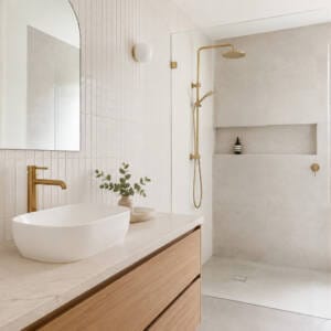 Brushed gold bathroom tapware styled with warm tiles in a Perth bathroom