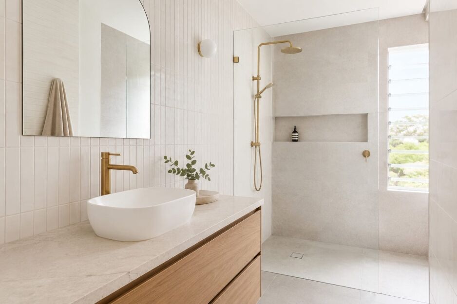 Brushed gold bathroom tapware styled with warm tiles in a Perth bathroom