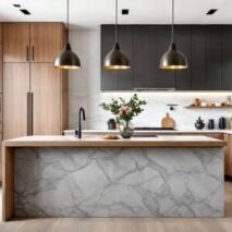 Luxury custom kitchen featuring black and wood cabinetry with a marble island and pendant lighting, showcasing a high-end modern design