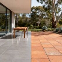 Side by side comparison of outdoor porcelain tiles vs pavers in a Perth backyard alfresco area