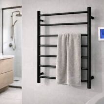 Matte black heated towel ladder with timer control installed in a modern bathroom