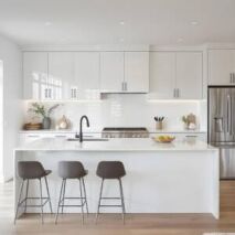 Modern white kitchen with sleek cabinetry and minimalist design, illustrating a practical kitchen cabinet buying guide for homeowners