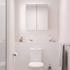 Compact toilet mirror cabinet installed above a white toilet in a minimalist powder room, showcasing modern space-saving bathroom storage ideas for Perth homes