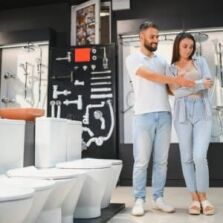 Couple browsing toilets and tapware in a modern Perth bathroom store, exploring fixtures and finishes for their renovation project